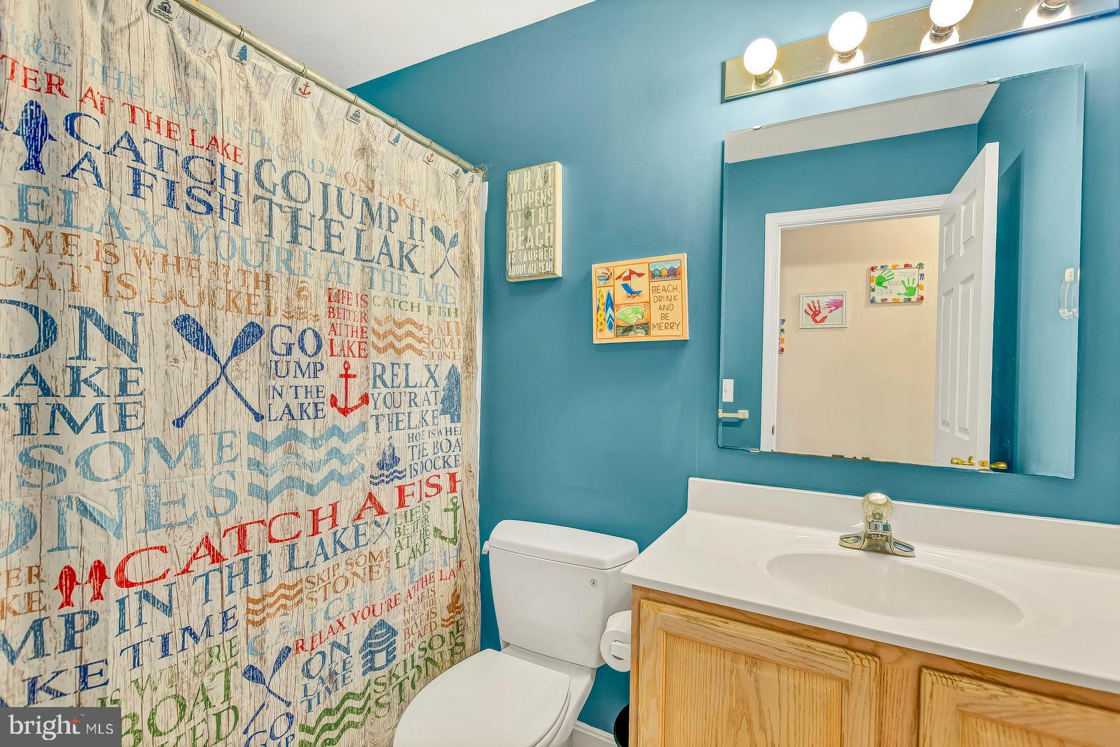 48948 Packer Court St. Inigoes, MD 20684 - Photo 28 of 45 a bathroom with a sink and a mirror