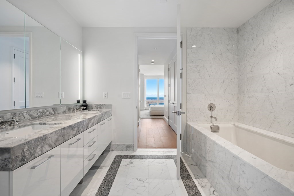 240 Devonshire Street, Unit 4210 Boston, MA 02110 - Photo 10 of 41 a spacious bathroom with a tub sink and mirror