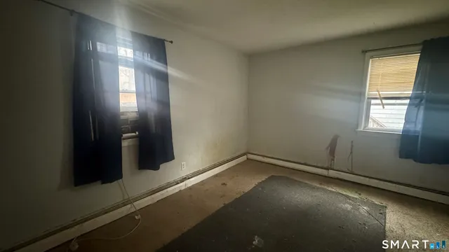 a room with granite countertop cabinets sink and window