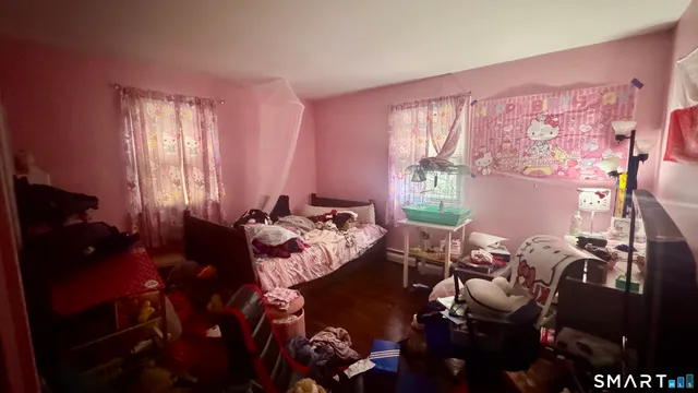 a bedroom with bed and a tv