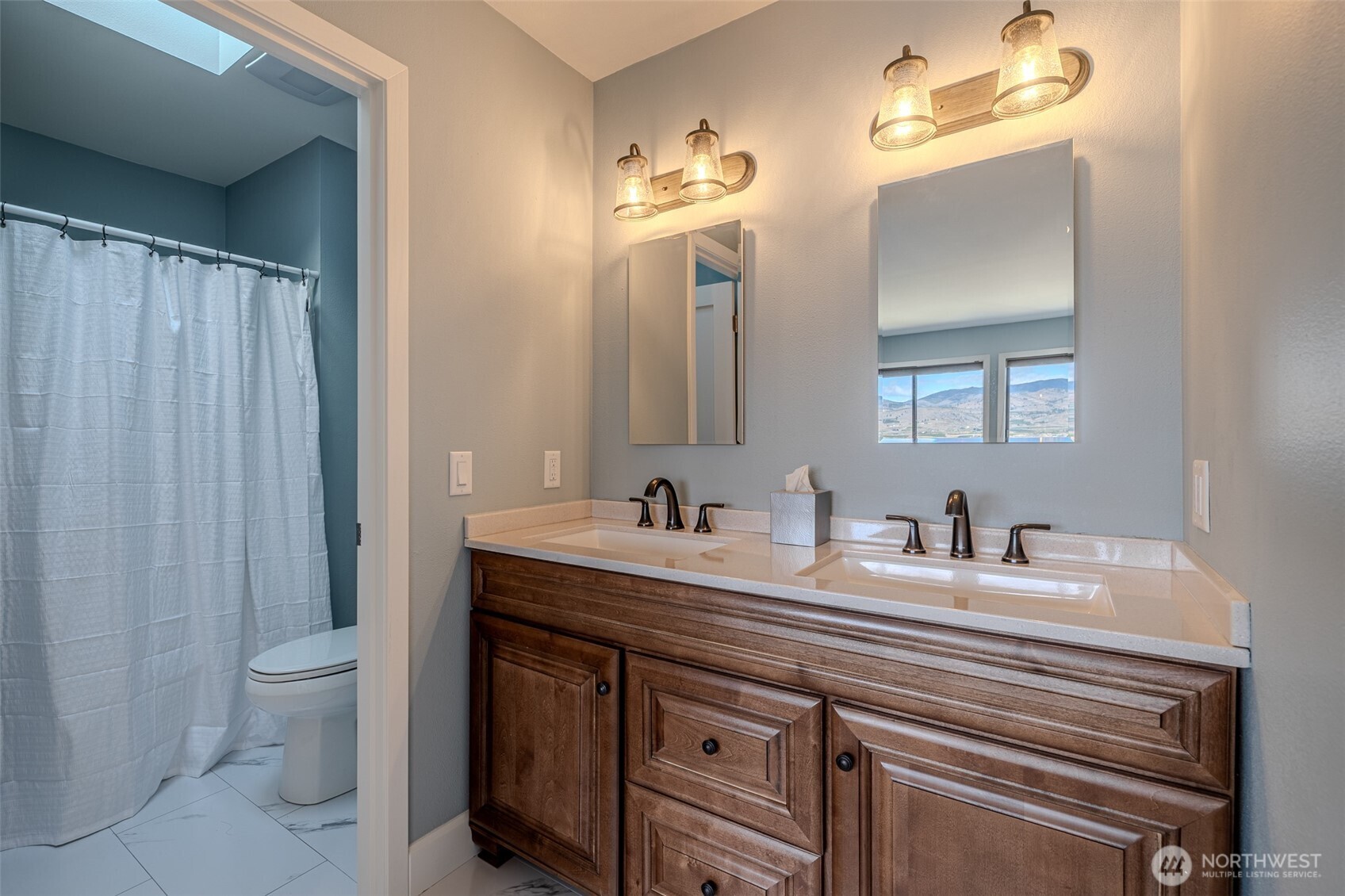 4124 Lakeview Place Chelan, WA 98816 - Photo 26 of 40 a bathroom with a double vanity sink and a toilet
