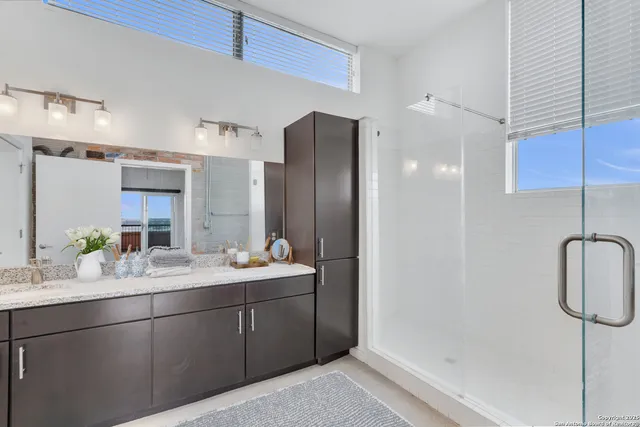 a bathroom with a double vanity sink mirror and double