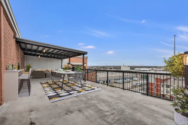 a view of a terrace with a table and chairs
