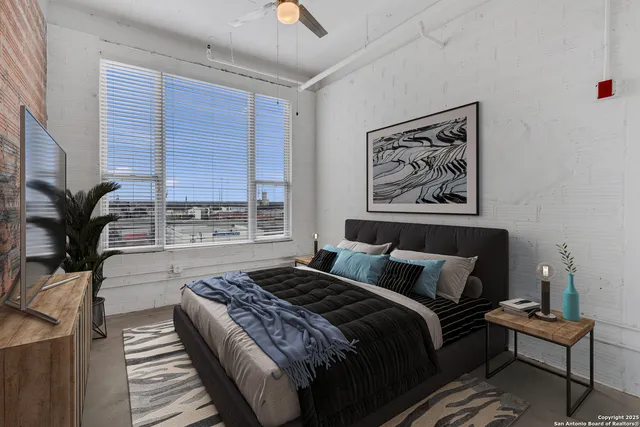 a bedroom with a bed and a window