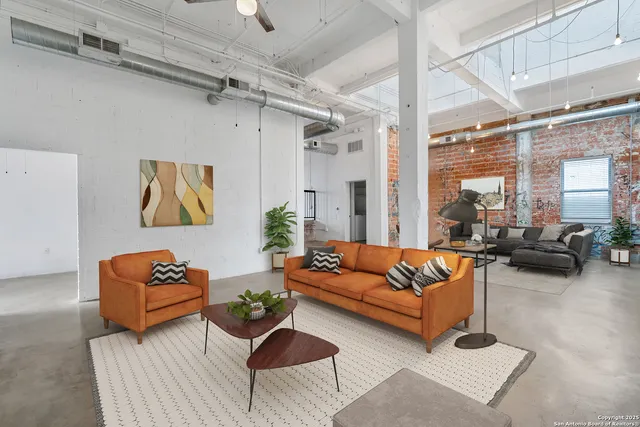 a living room with furniture or couch and a potted plant