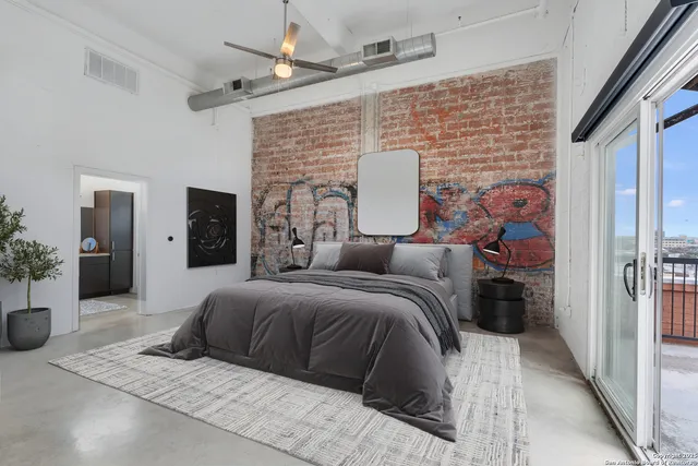 a spacious bedroom with a bed and a couch