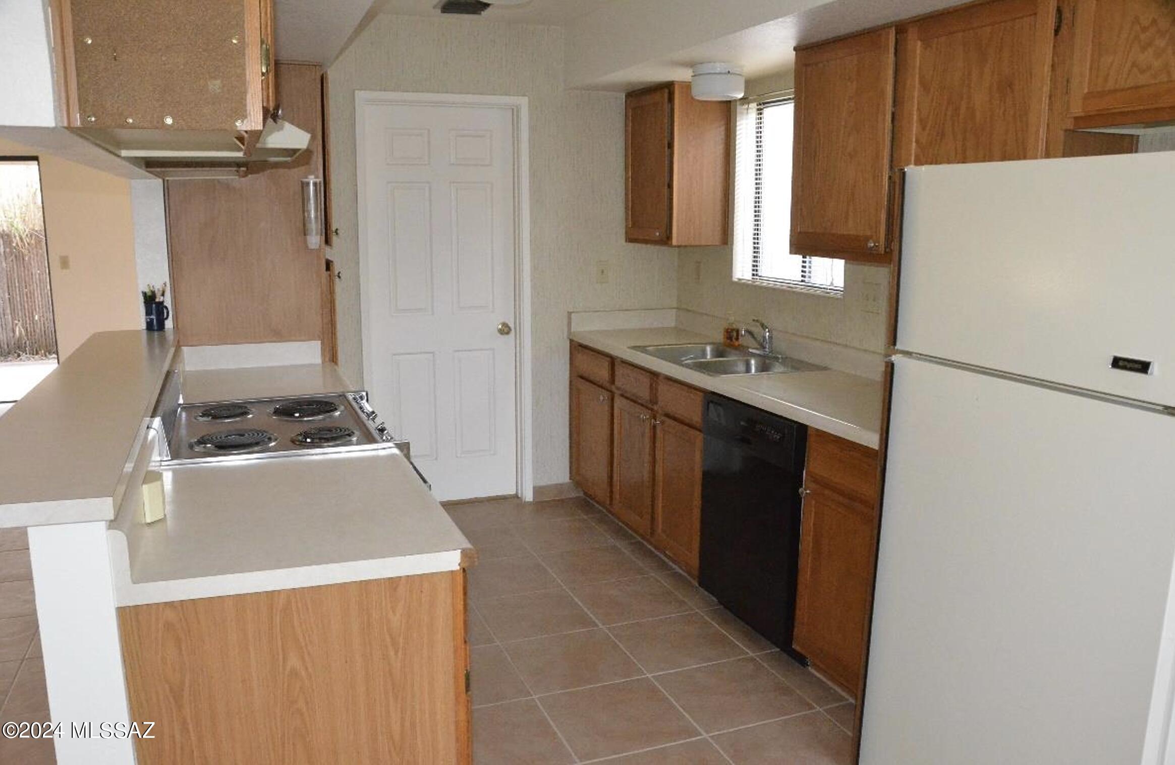 2118 North Ralph Avenue Tucson, AZ 85712 - Photo 8 of 10 a kitchen with a stove and a refrigerator