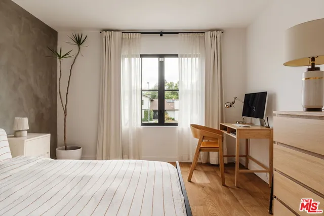 a bedroom with bed and walk in closet