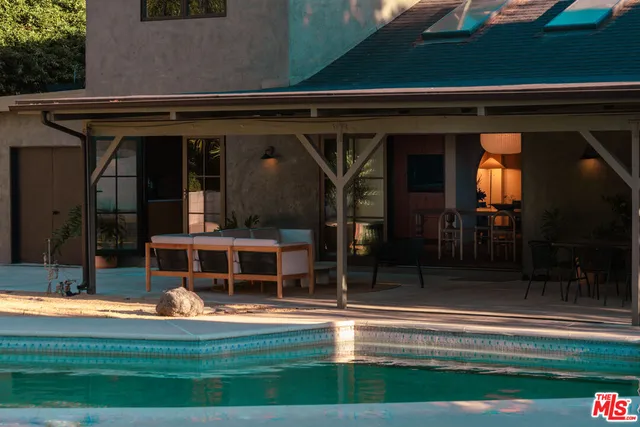 a view of swimming pool with outdoor seating