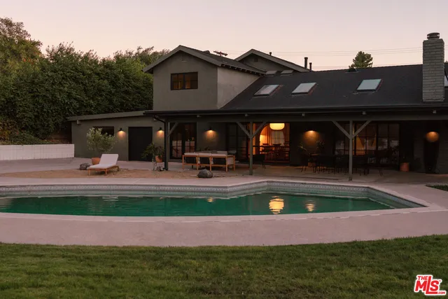 a front view of a house with plants