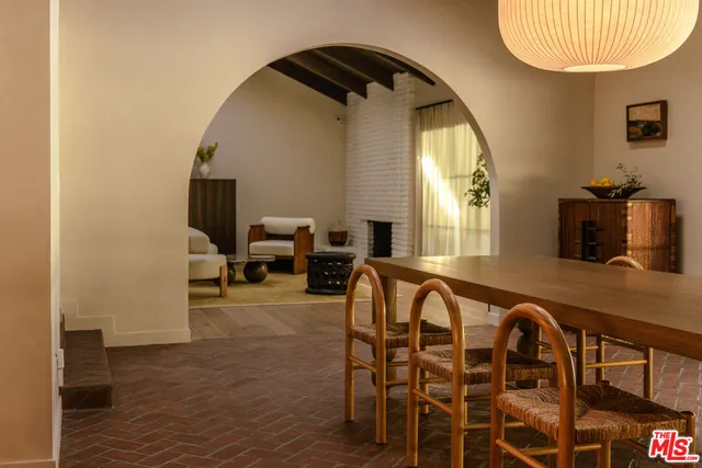 a view of a dining room with furniture and a mirror