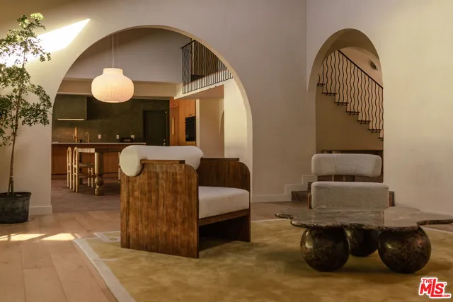 a living room with furniture and a mirror