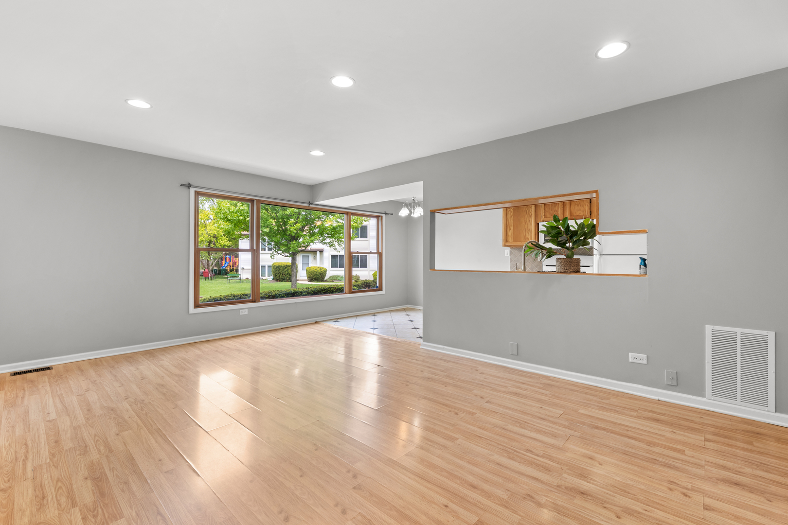 146 Inverrary Lane, Unit 146 Deerfield, IL 60015 - Photo 10 of 19 a view of an empty room with wooden floor and a window