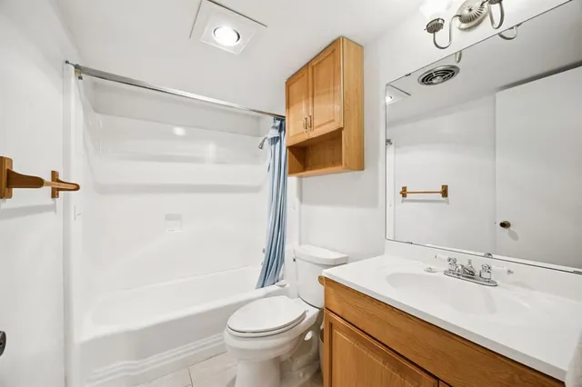 a bathroom with a sink toilet vanity and shower