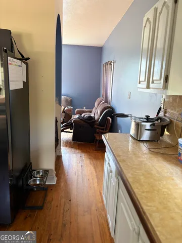 a kitchen with sink refrigerator and stove