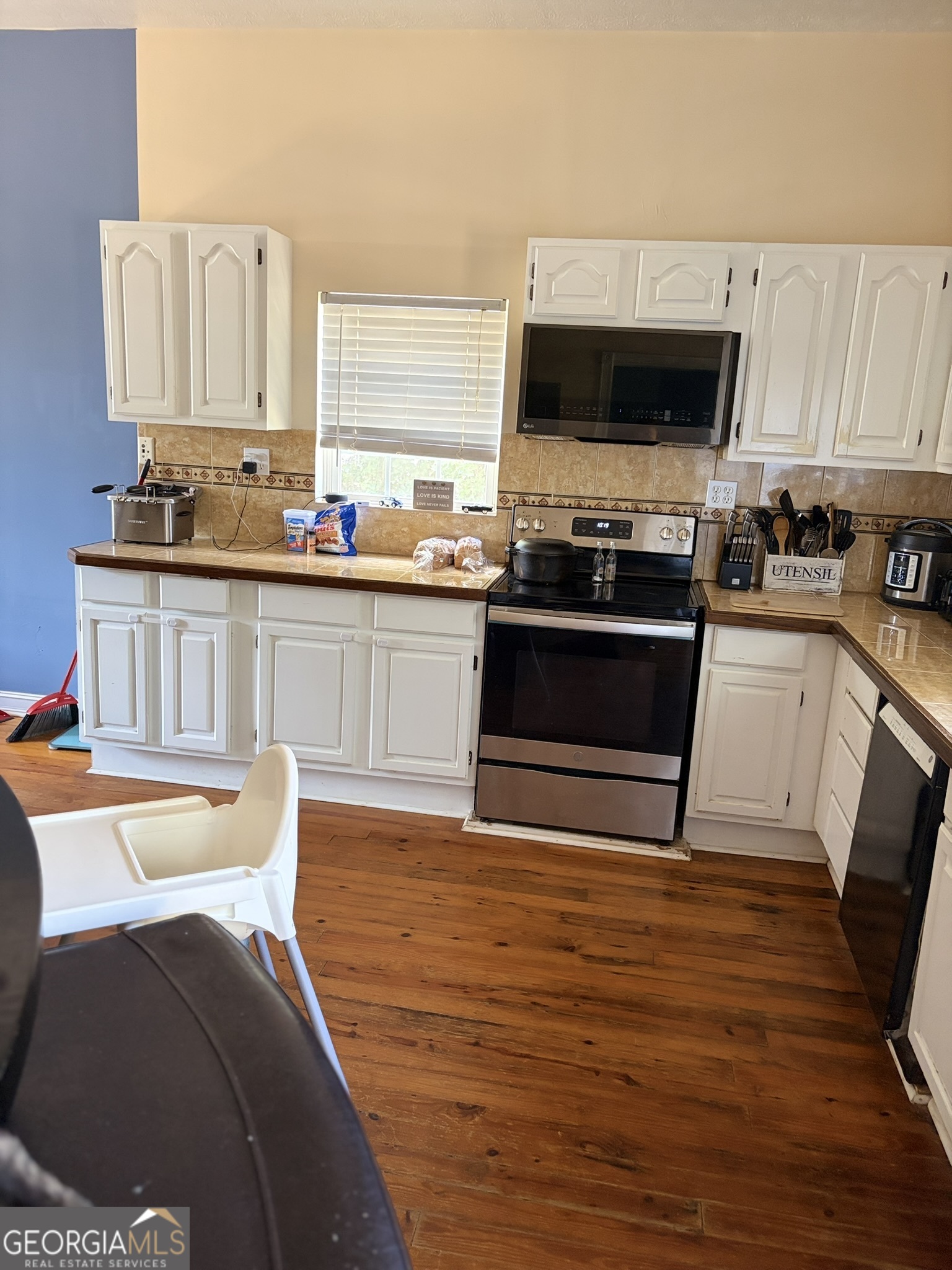 80 Baugh Street Commerce, GA 30529 - Photo 17 of 31 a kitchen with stainless steel appliances a stove sink and microwave