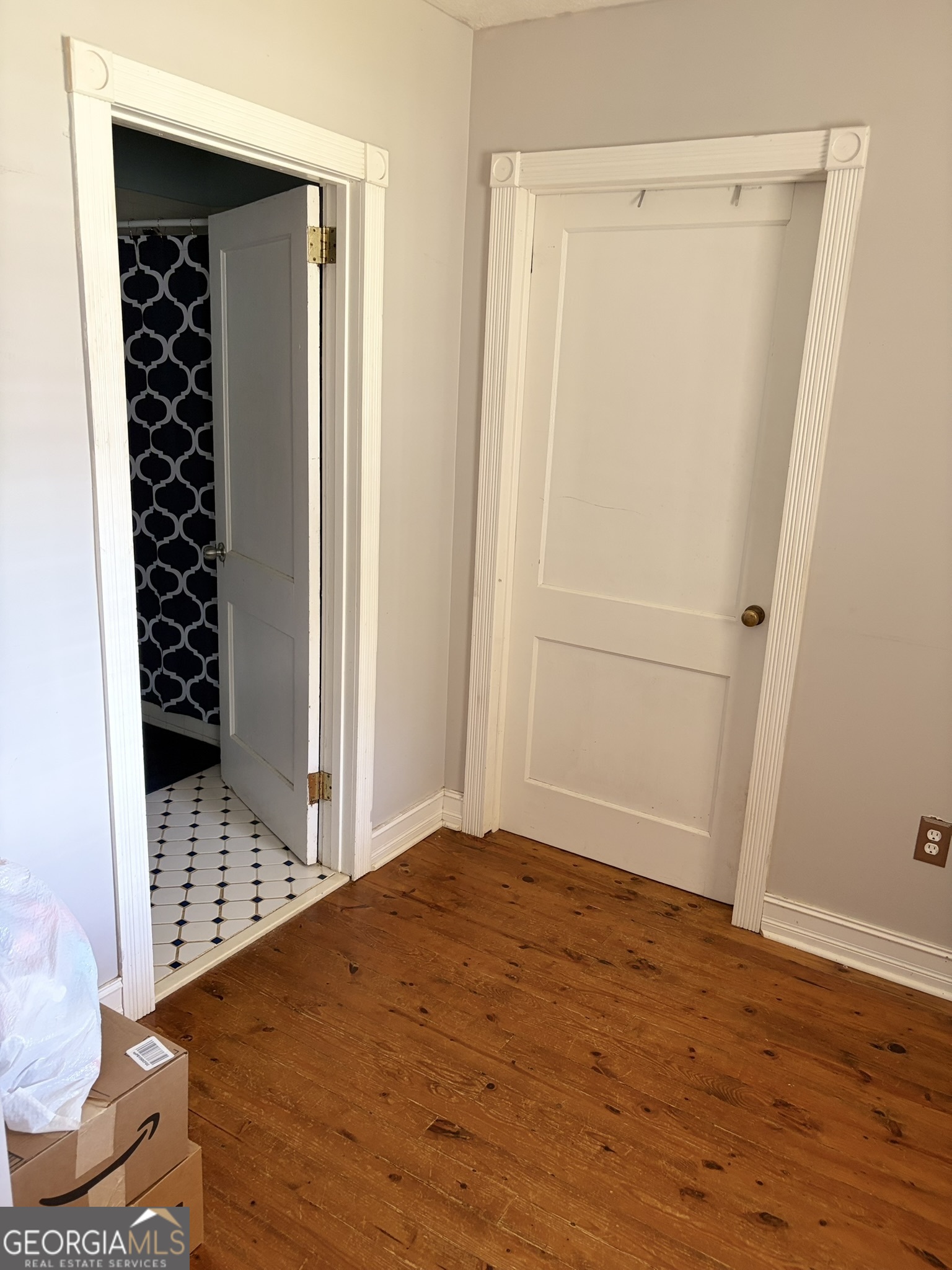 80 Baugh Street Commerce, GA 30529 - Photo 18 of 31 a bedroom with a bed and wooden floor