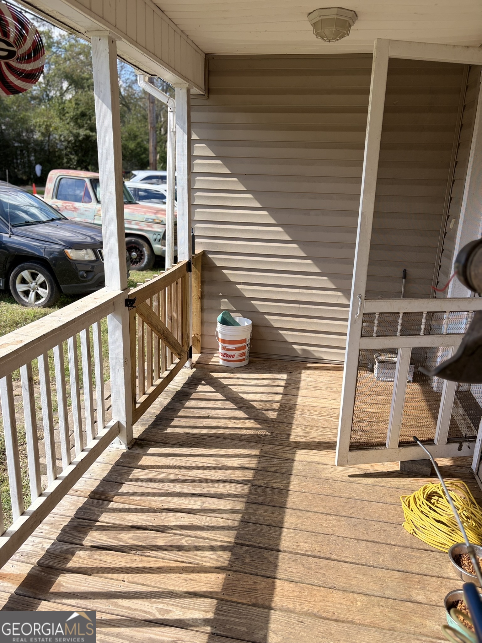 80 Baugh Street Commerce, GA 30529 - Photo 2 of 31 a view of a balcony with two chairs and wooden floor