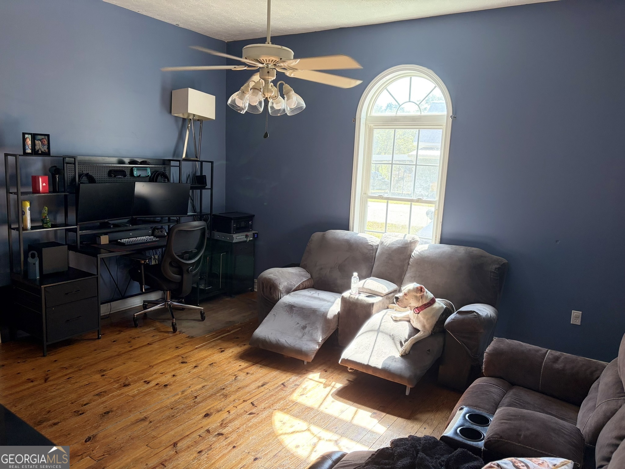 80 Baugh Street Commerce, GA 30529 - Photo 22 of 31 a living room with furniture a chandelier and a flat screen tv