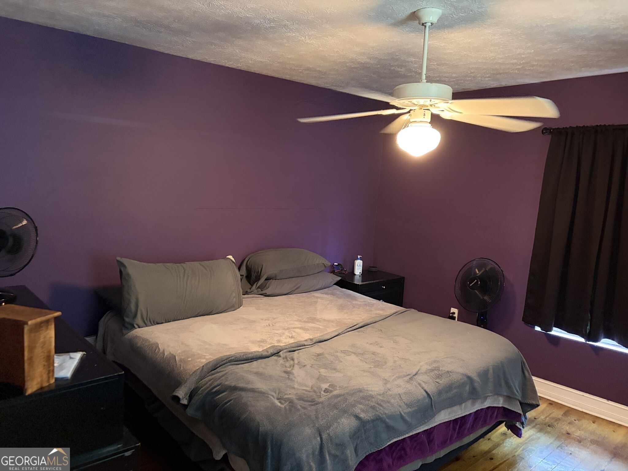 80 Baugh Street Commerce, GA 30529 - Photo 4 of 31 a bedroom with a bed and a chandelier