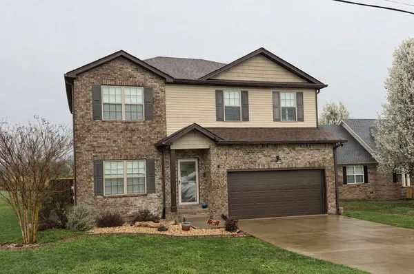 a front view of a house with a yard and garage