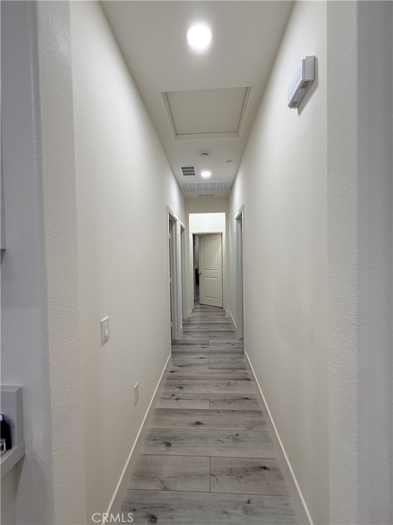 4067 Summer Corona, CA 92883 - Photo 5 of 12 Interior hallway with recessed lighting and luxury vinyl plank flooring throughout.
