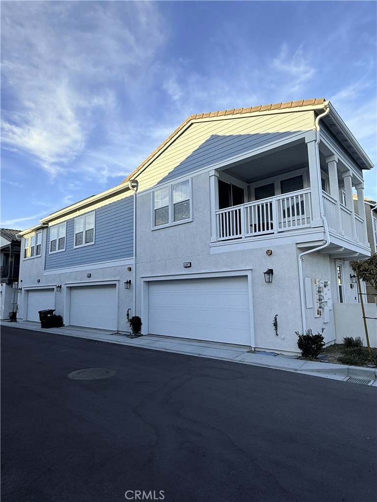 4067 Summer Corona, CA 92883 - Photo 6 of 12 Rear exterior featuring attached two-car garage and alley access.