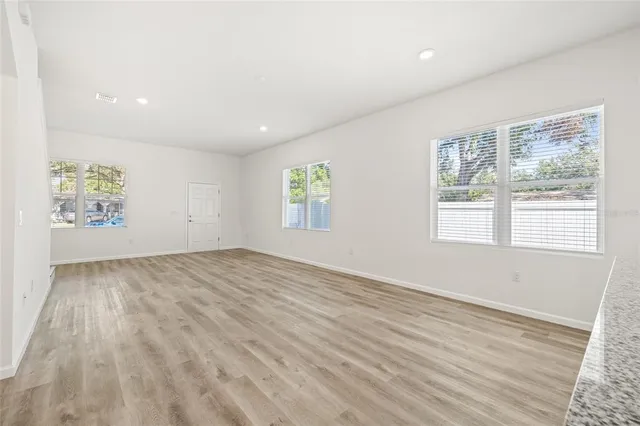 a kitchen with stainless steel appliances kitchen island granite countertop a stove a sink and a refrigerator