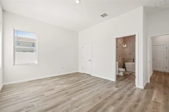 a bathroom with a granite countertop sink a toilet and shower