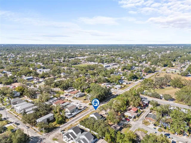 an aerial view of a house with a swimming pool