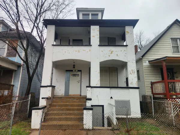 a front view of a house with wooden stairs