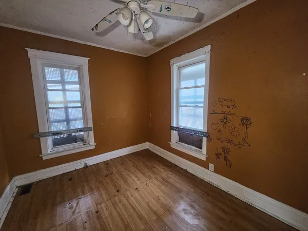 wooden floor in an empty room with a window
