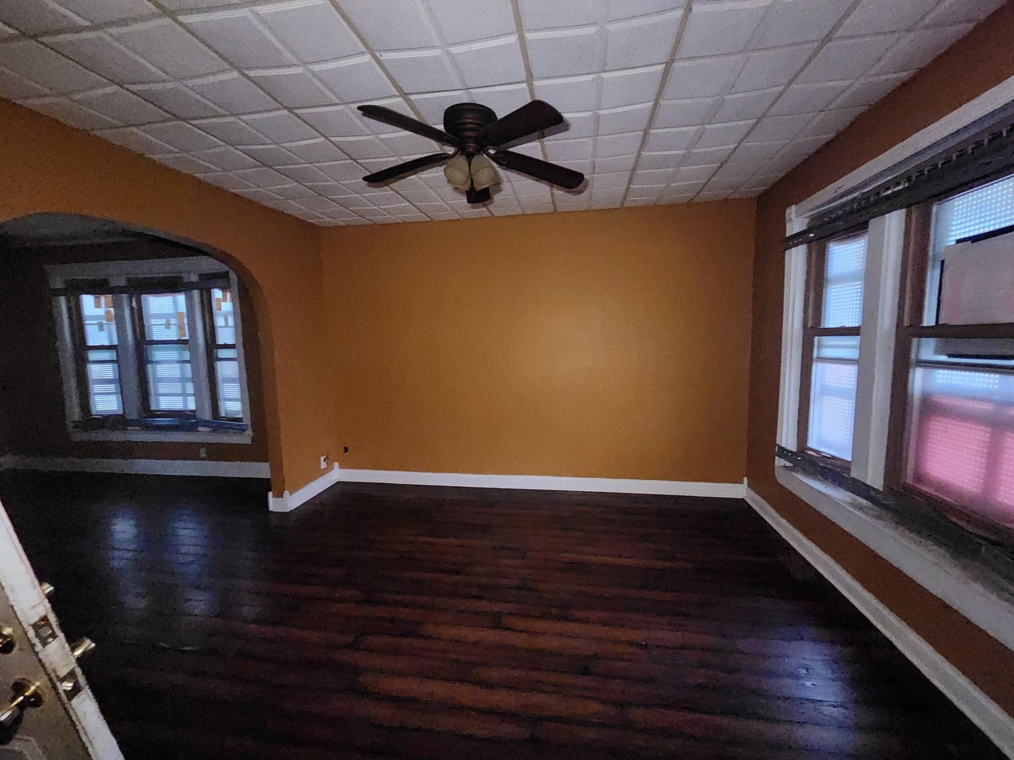18 West 114th Street Chicago, IL 60628 - Photo 5 of 14 a view of an empty room with a window and wooden floor