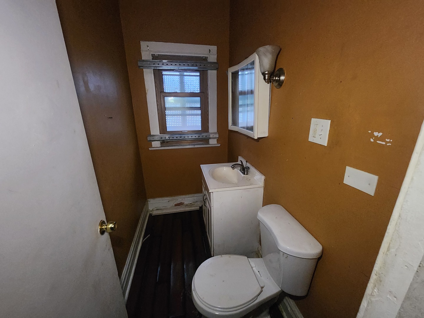 18 West 114th Street Chicago, IL 60628 - Photo 8 of 14 a white toilet sitting next to a bathroom sink and a window