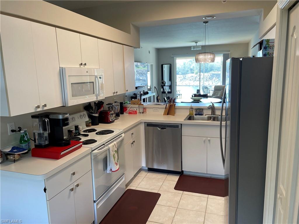 Undisclosed Address Naples, FL 34112 - Photo 11 of 28 a kitchen with a sink cabinets and appliances