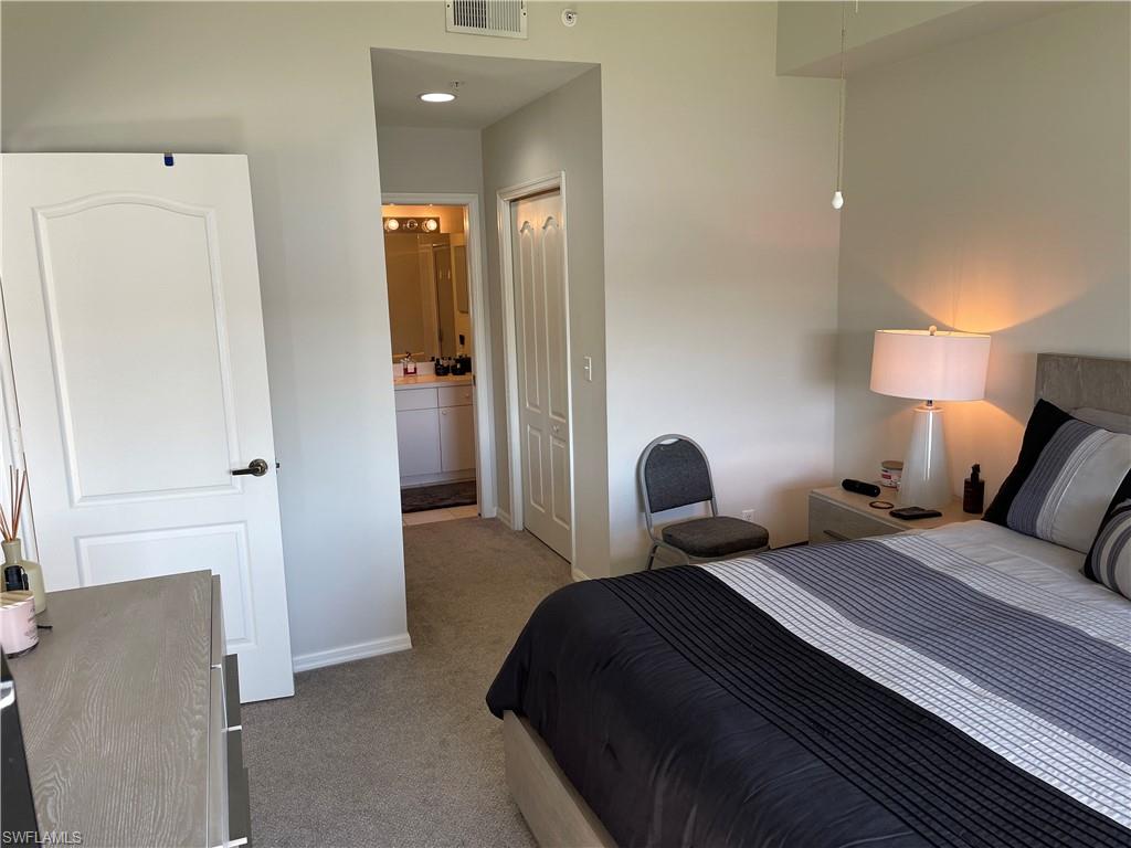Undisclosed Address Naples, FL 34112 - Photo 13 of 28 a bedroom with a bed and a lamp
