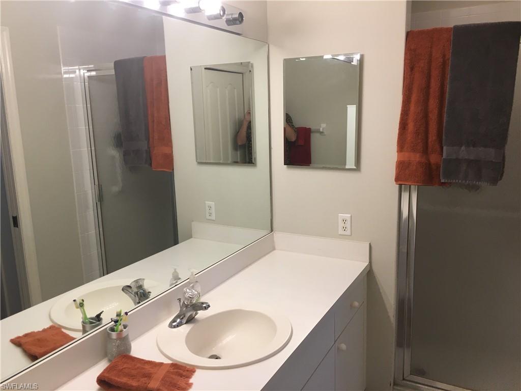 Undisclosed Address Naples, FL 34112 - Photo 14 of 28 a bathroom with a sink and a mirror