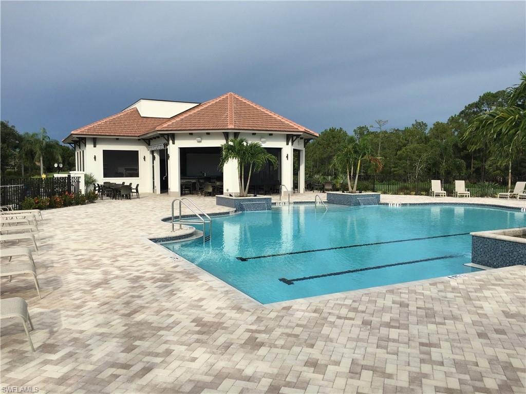 Undisclosed Address Naples, FL 34112 - Photo 18 of 28 a front view of a house with a yard