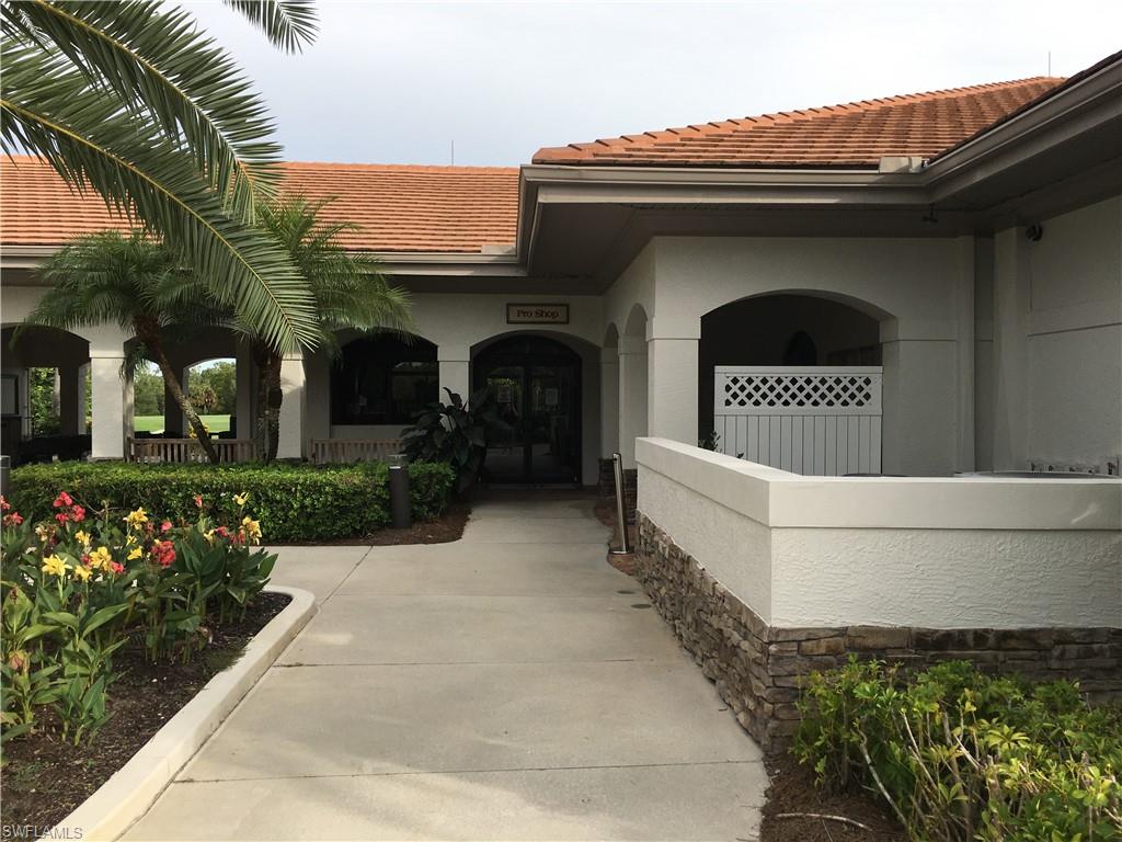 Undisclosed Address Naples, FL 34112 - Photo 21 of 28 a front view of a house with a garden