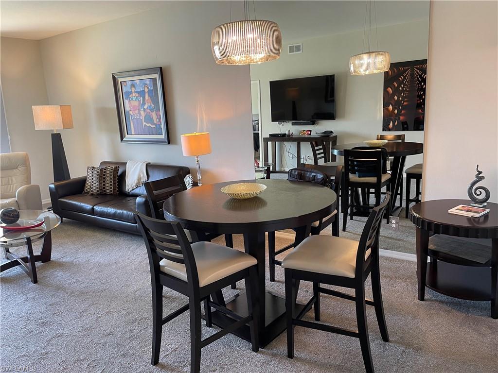 Undisclosed Address Naples, FL 34112 - Photo 4 of 28 a view of a dining room with furniture and wooden floor