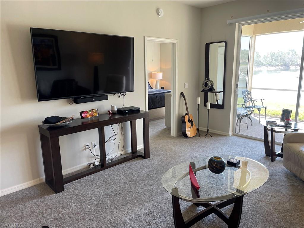 Undisclosed Address Naples, FL 34112 - Photo 7 of 28 a living room with furniture and a flat screen tv