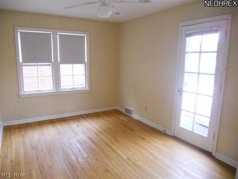 2168 Vernon Road University Heights, OH 44118 - Photo 8 of 11 Bedroom #2 with Gleaming Hardwood Floors and Door Leading to Deck/Balcony