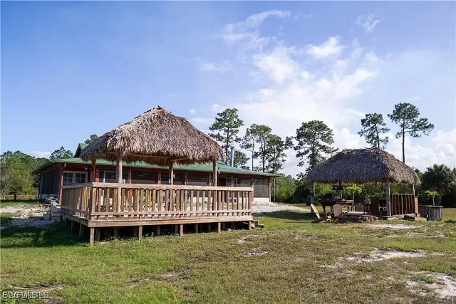 a view of a house with a yard and sitting area