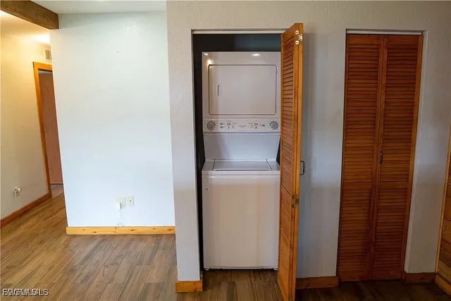 a view of walk in closet with wooden floor