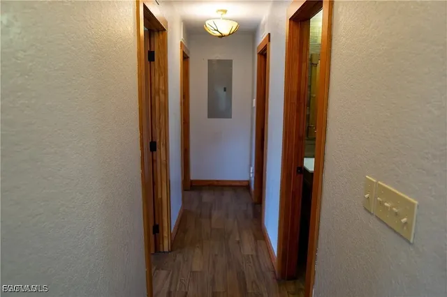 a view of a hallway with wooden floor