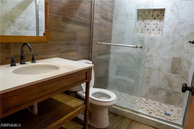 a bathroom with a sink toilet and shower