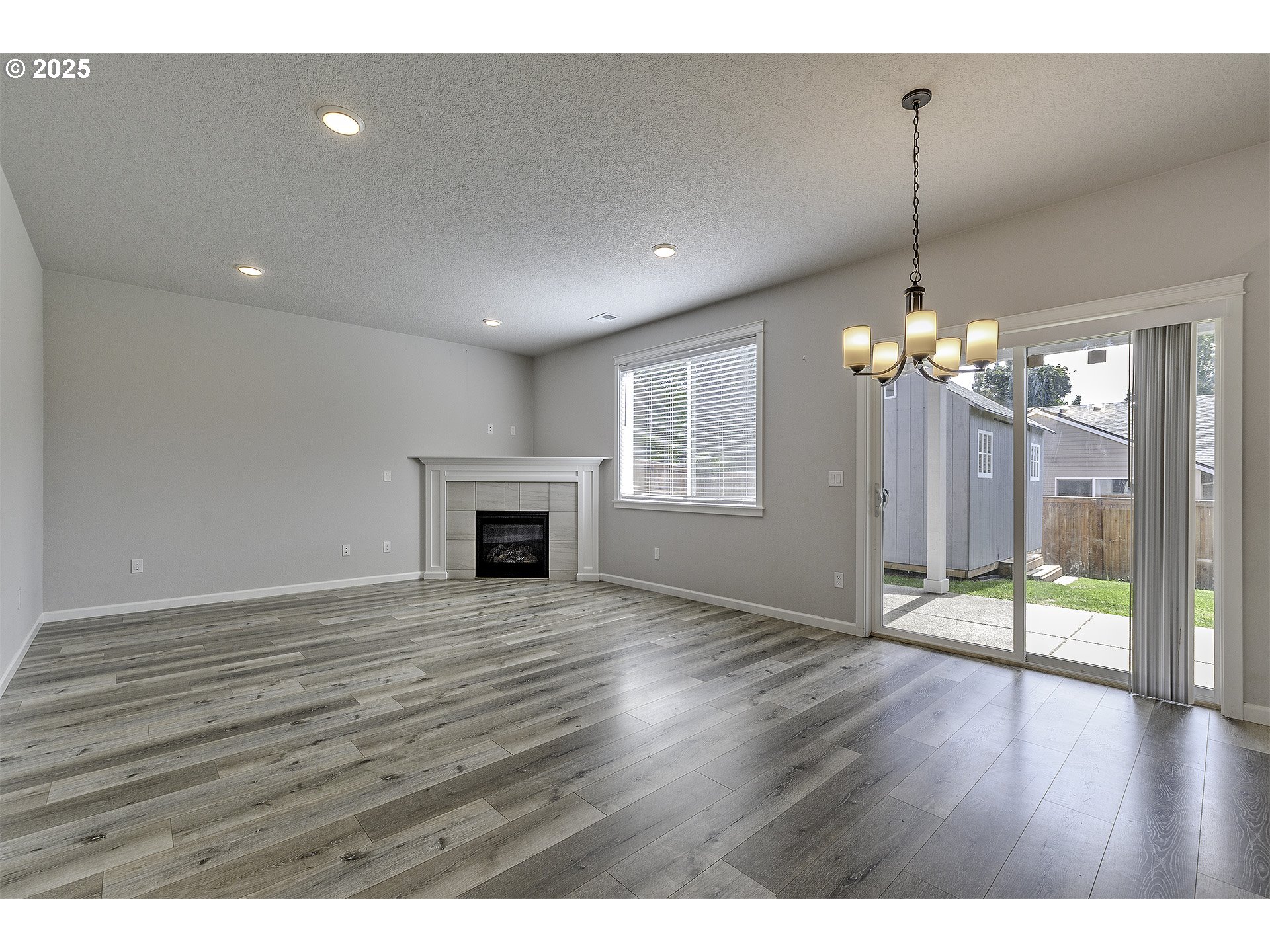 1015 South Nectarine Street Cornelius, OR 97113 - Photo 15 of 36 a view of an empty room with wooden floor and a fireplace
