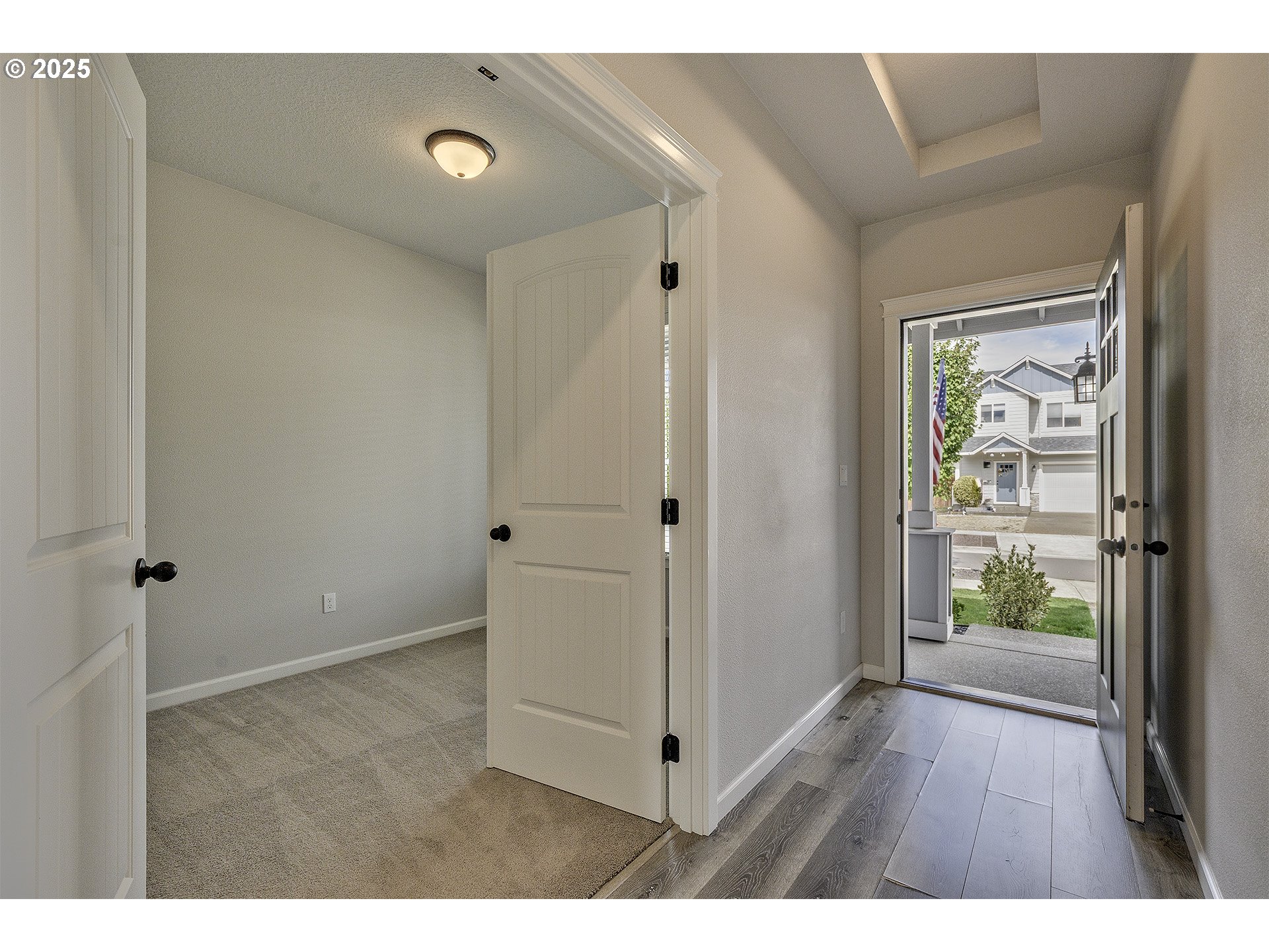 1015 South Nectarine Street Cornelius, OR 97113 - Photo 2 of 36 a view of an empty room with wooden floor and a window