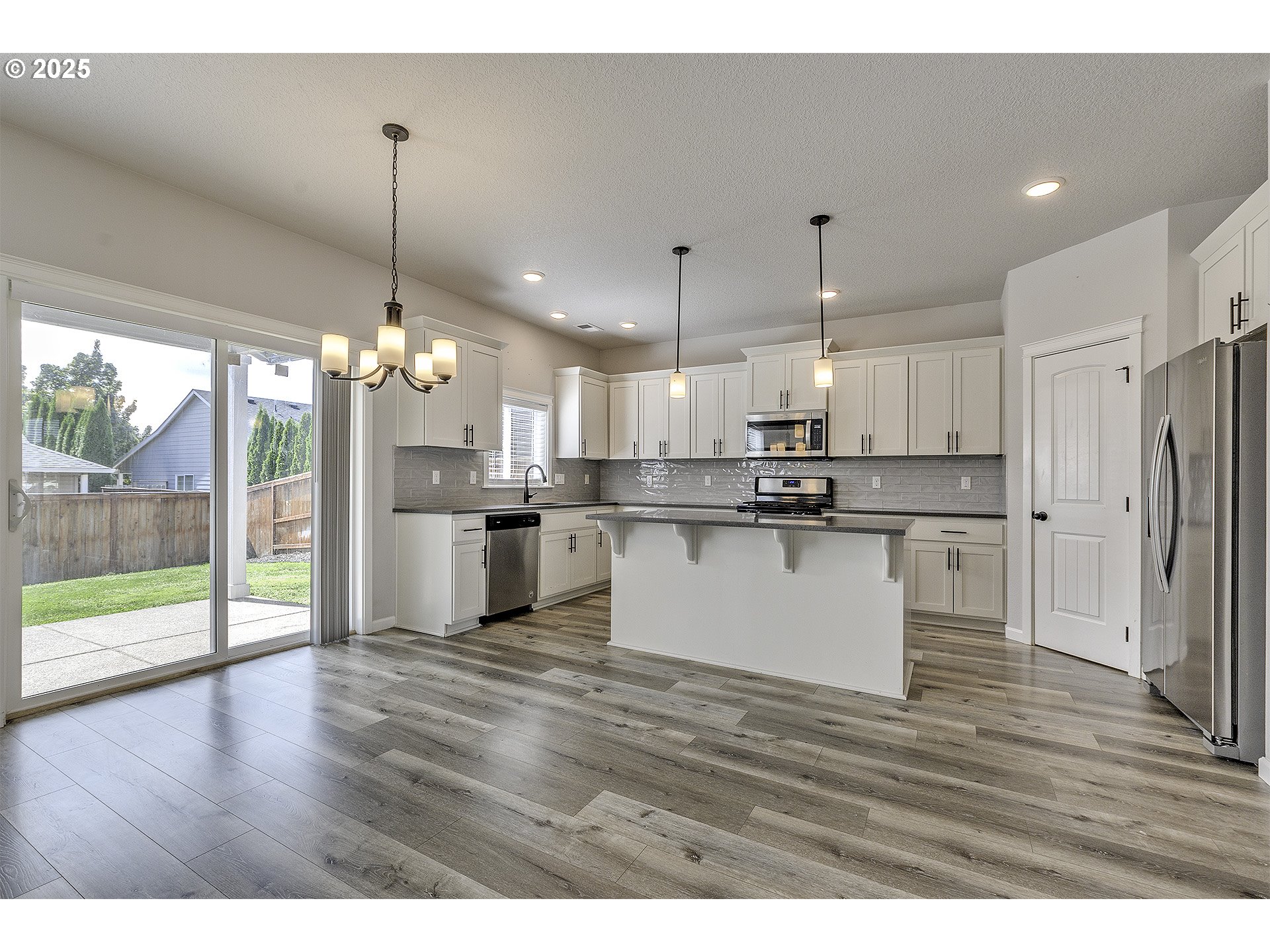 1015 South Nectarine Street Cornelius, OR 97113 - Photo 7 of 36 a view of kitchen with refrigerator and wooden floor