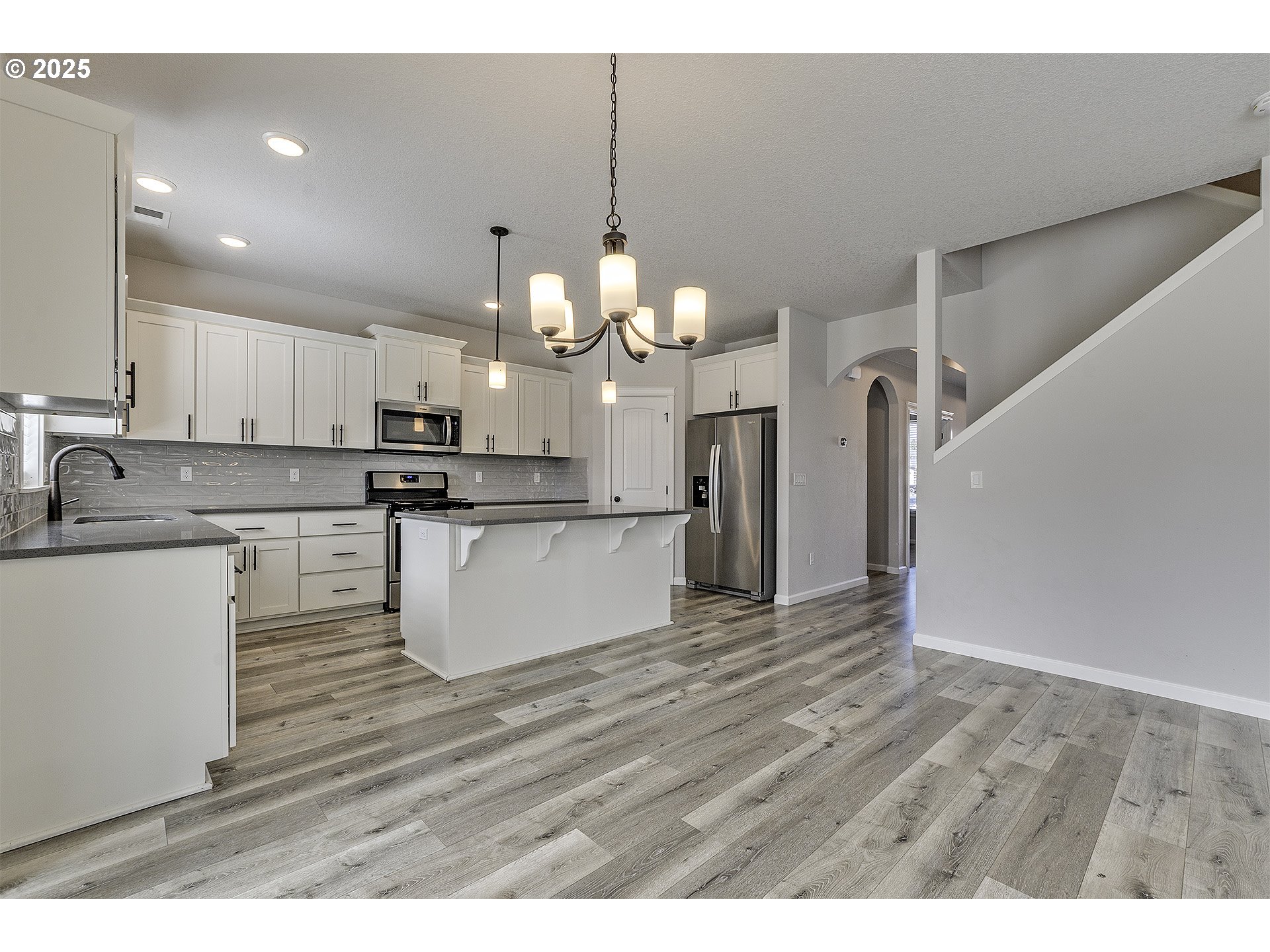 1015 South Nectarine Street Cornelius, OR 97113 - Photo 8 of 36 a kitchen with stainless steel appliances granite countertop a sink a stove a refrigerator and white cabinets